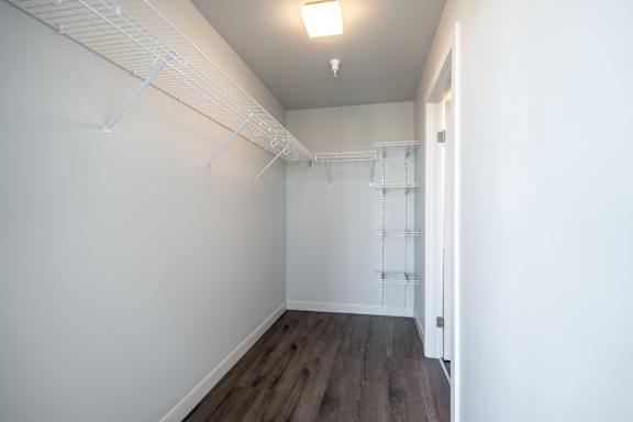 Empty room with white walls and wooden floor.