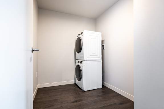 A white washing machine and dryer in a small room.
