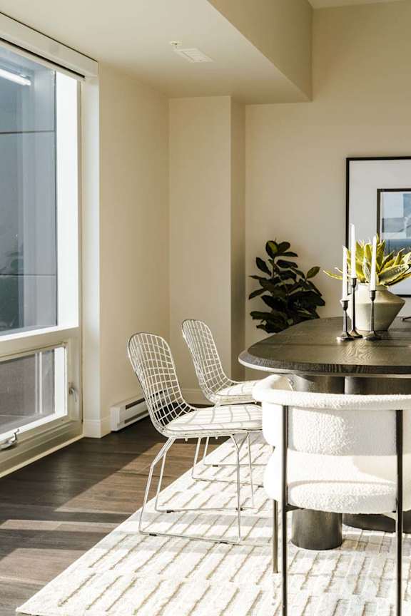 A dining room with a table and chairs.