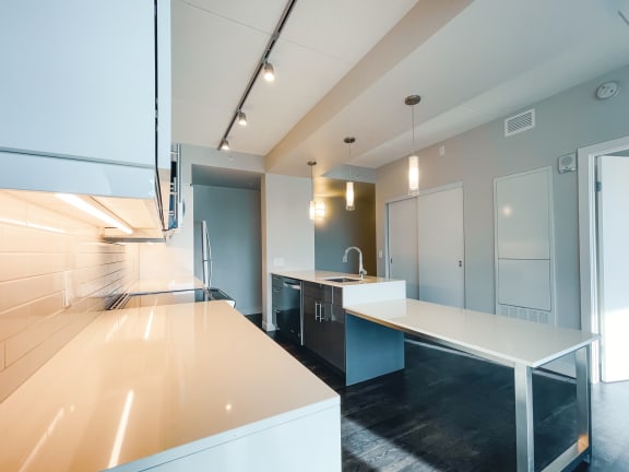 a kitchen with white countertops and blue cabinets
