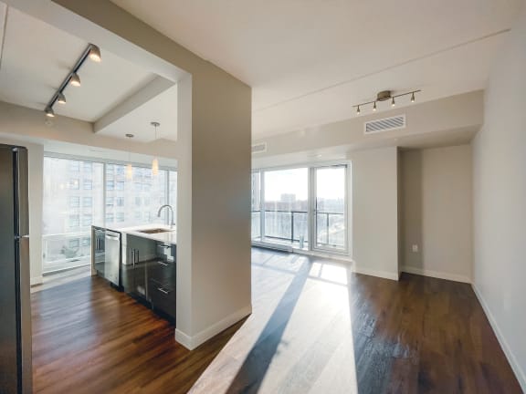 a kitchen with hardwood floors and a large window