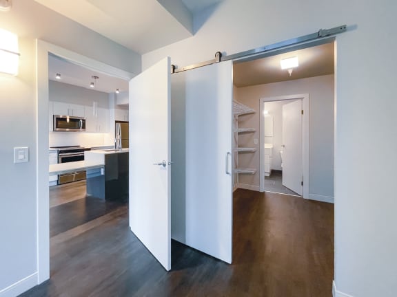 a sliding barn door divides a kitchen from a living room