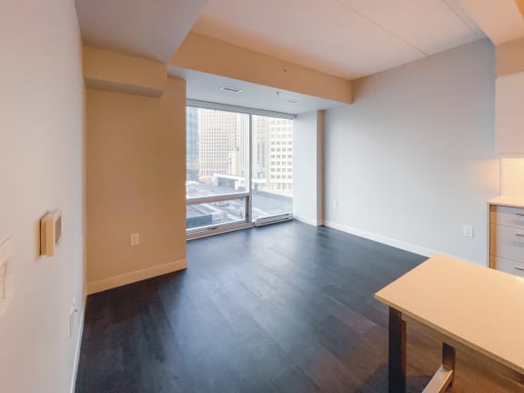 an empty living room with a view of the city