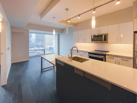 a kitchen and living room in an apartment