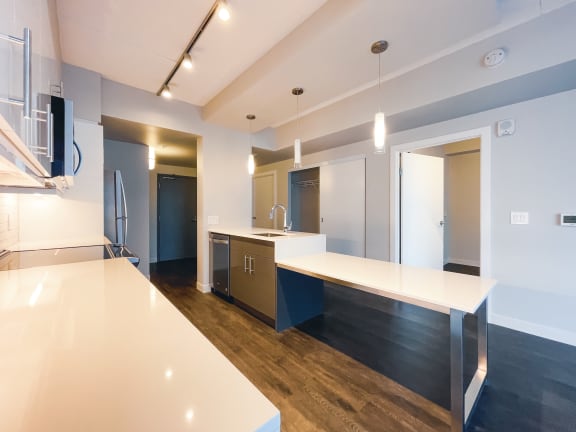 a kitchen with white countertops and blue cabinets