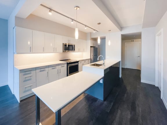 a kitchen with white countertops and white cabinets