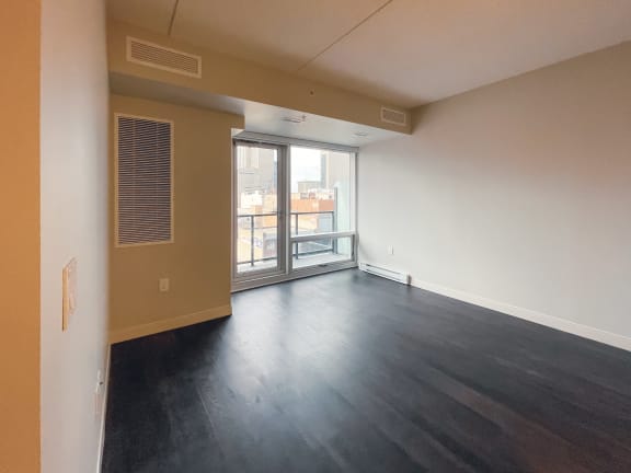 an empty living room with a balcony
