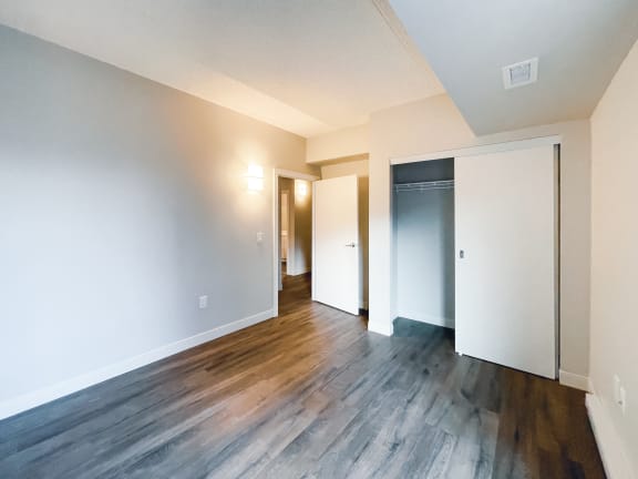 a living room with hardwood floors and white walls