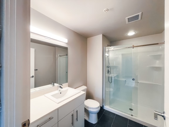 a bathroom with a toilet sink and shower