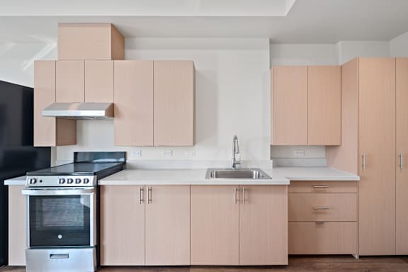 A modern kitchen with a black oven and a sink.