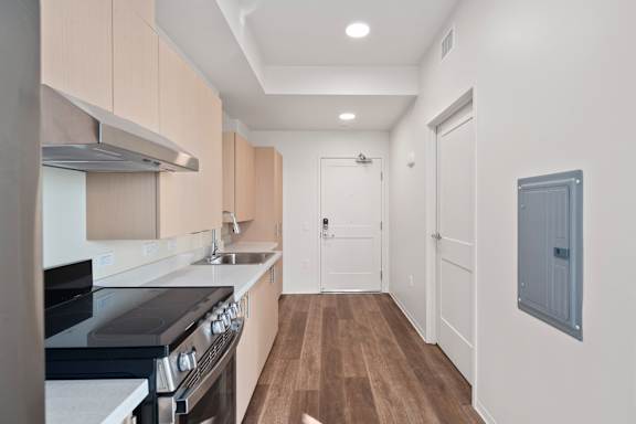 A kitchen with a stove top oven and a sink.