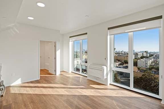 A room with a view of the city through the windows.