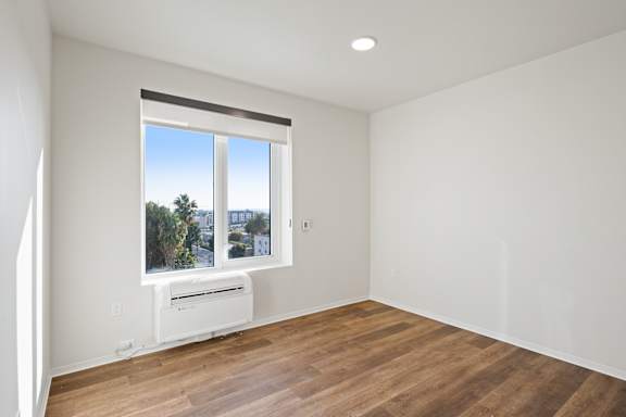 A room with a window overlooking a cityscape.