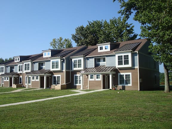 a row of houses with cars parked in front of them