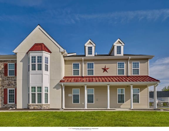 a story house with a red roof on the side