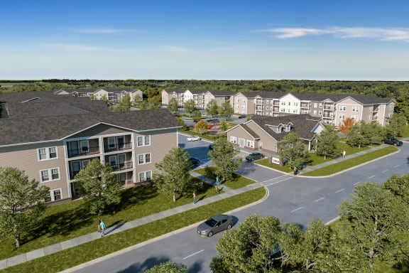 an aerial view of a large apartment complex with a pool in the middle of the parking lot