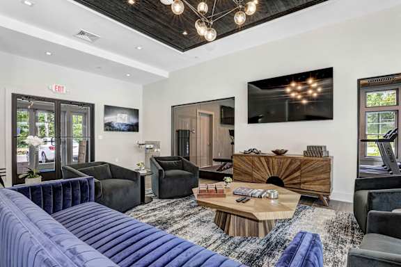 A living room with a blue couch and a wooden coffee table.