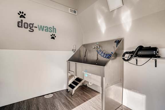 A dog wash station with a sign on the wall.