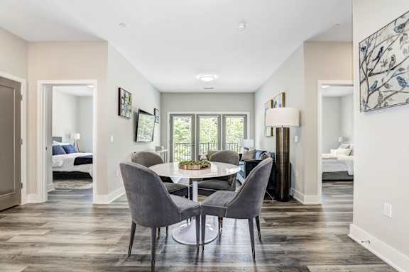 A dining room with a table and chairs.