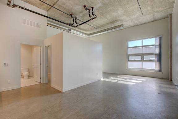 A large empty room with a toilet in the corner at RiDE at RiNo Apartments, Denver
