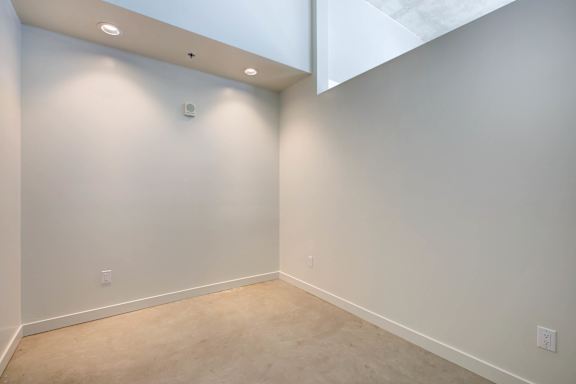 A room with white walls and a light brown carpet at RiDE at RiNo Apartments, Denver 80216