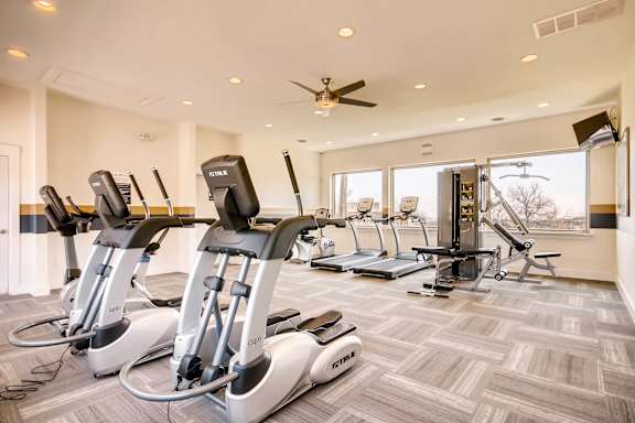 A gym with treadmills and elliptical machines at Mountain Vista Apartments, Colorado, 80228