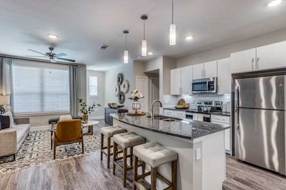 A modern kitchen with a bar stool and a countertop.