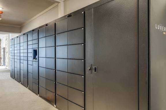 A row of black lockers with the word "LUXER" on the right side.