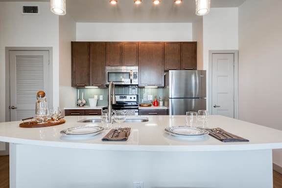 Modern Kitchen with white island at Agave, San Antonio