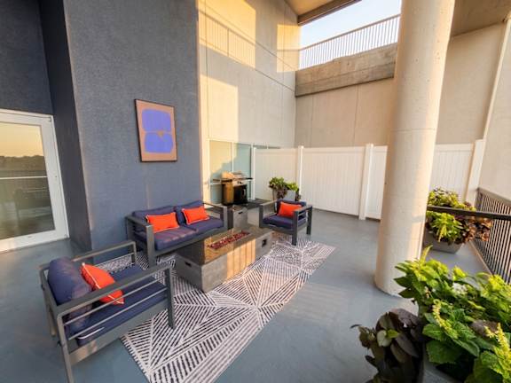 Outdoor terrace with modern furniture and planters at 222 Saratoga Apartments, Maryland, 21202