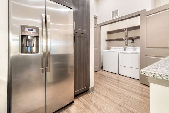 A stainless steel refrigerator with a water and ice dispenser in the door.at The Bridge at McKinney, McKinney, TX 75069