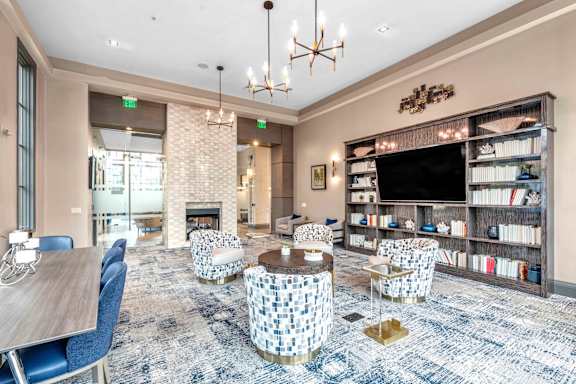 A living room with a fireplace and a bookshelf.