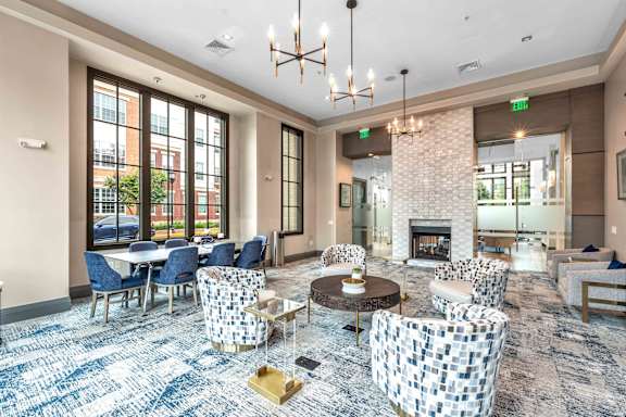 A large room with a fireplace and a chandelier.