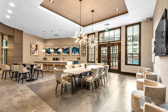A large dining room with a long table and chairs.