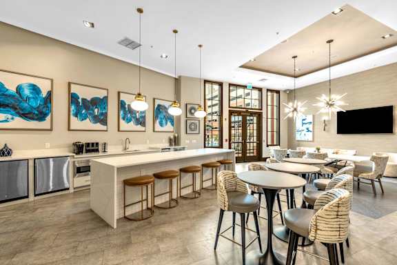 A modern kitchen with a bar area and a dining table.