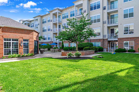A large grassy area in front of apartment buildings.
