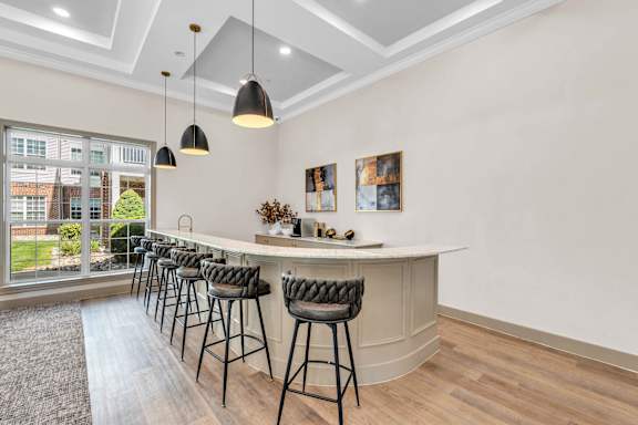 A bar area with a row of black stools.