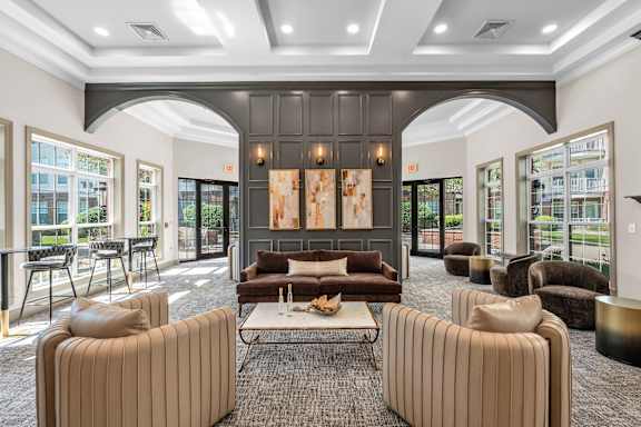 A modern living room with a large painting and a coffee table.