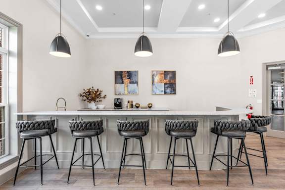 A kitchen with a bar area featuring a counter and bar stools.