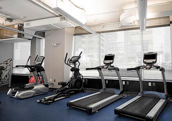 Fitness center with treadmills and elliptical machines at 222 Saratoga Apartments, Baltimore, 21202