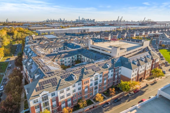 an aerial view of a building under construction with a city in the background at Harbor Pointe, Bayonne