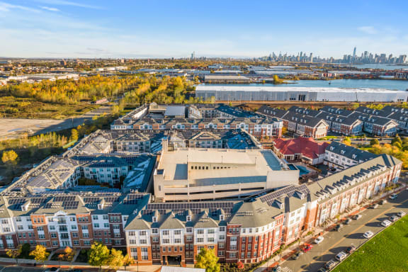 an aerial view of houses in front of a body of water and a cityat Harbor Pointe, New Jersey, 07002