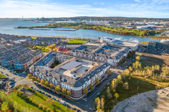 an aerial view of a city with buildings and a body of water at Harbor Pointe, Bayonne, New Jersey