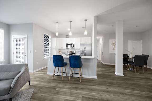 A modern kitchen with a dining table and chairs.