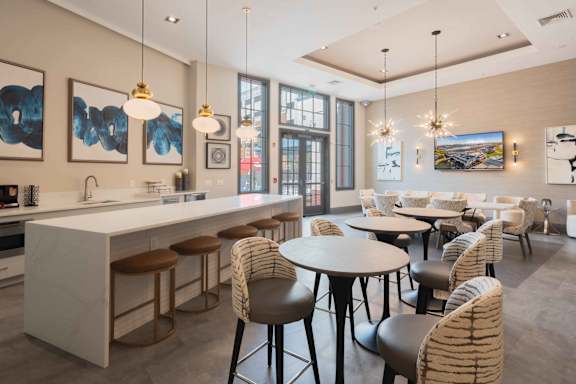 A modern clubhouse with kitchen with a bar area and dining area at Harbor Pointe Apartments, New Jersey, 07002