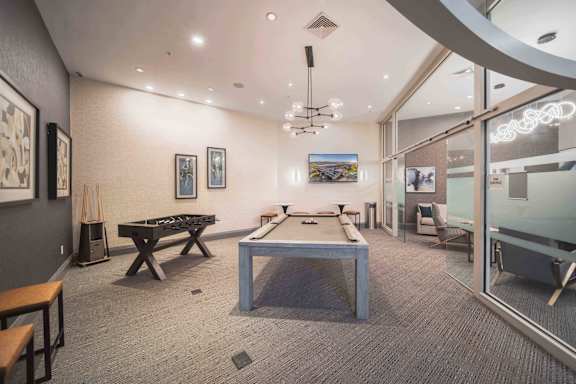 A room with a pool table and a TV mounted on the wall at Harbor Pointe Apartments, Bayonne, NJ