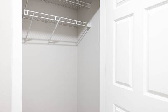 A white door with a white interior and a white ceiling with a light fixture.