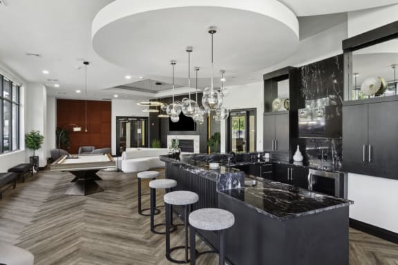 a large kitchen with marble counter tops and bar stools at Metro 303, Hempstead