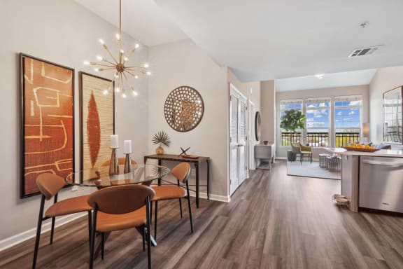 a dining room and living room with a table and chairs at Metro 303, Hempstead, NY 11550