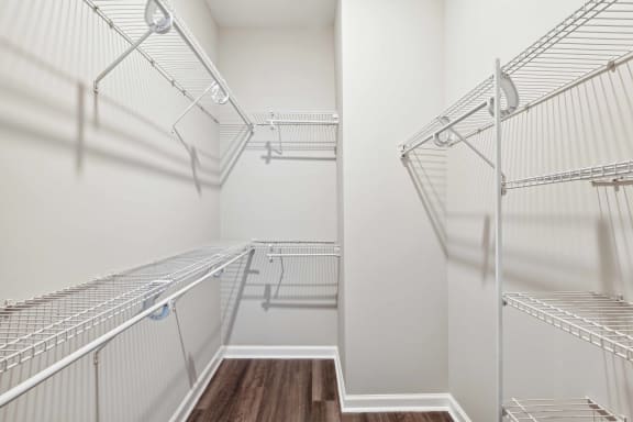 the walk in closet of a bedroom with mirrored closets at Metro 303, Hempstead, NY